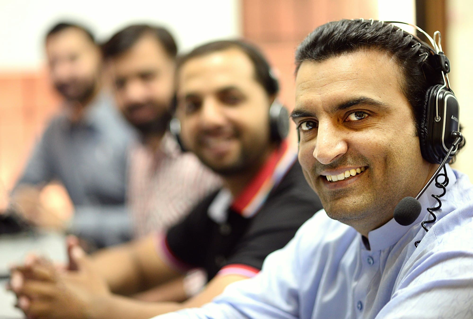 Knovatik agents on the floor wearing headsets